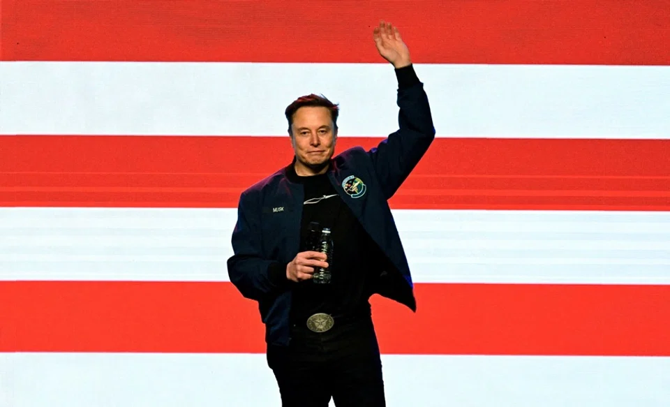 Elon Musk waves on the day of a rally in support of a conservative state Supreme Court candidate of a 1 April election in Green Bay, Wisconsin, US, on 30 March 2025. (Vincent Alban/Reuters)