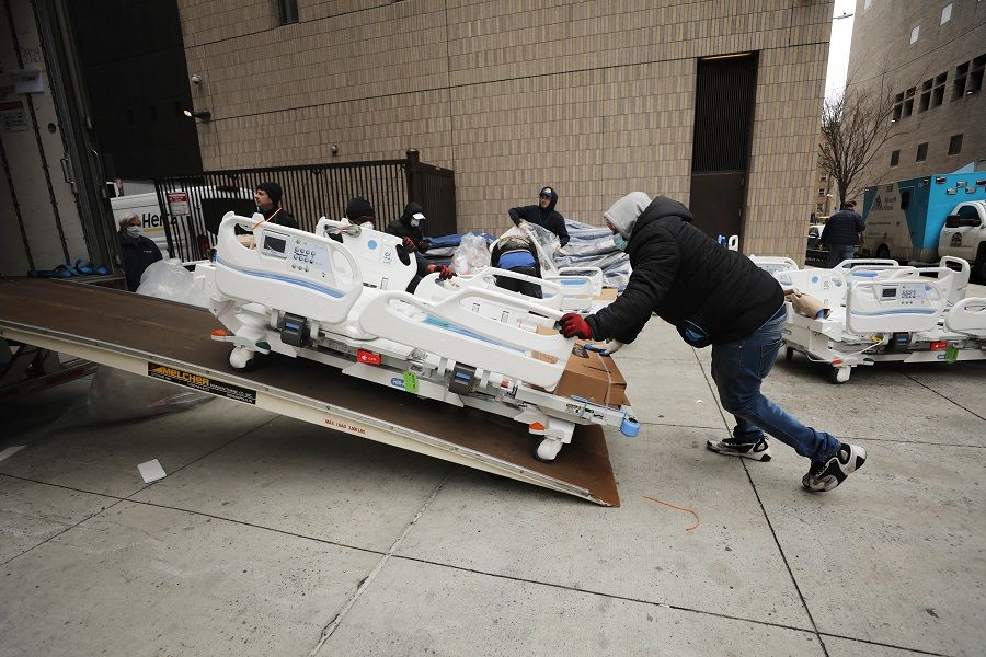 Workers prepare dozens of extra medical beds as they are delivered to Mount Sinai Hospital amid the coronavirus pandemic on 31 March 2020 in New York City. (Spencer Platt/Getty Images/AFP)