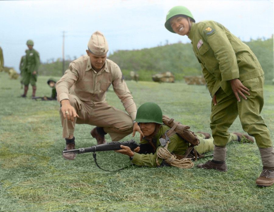 A KMT soldier adjusts his position under the guidance of a US army instructor, 1954.