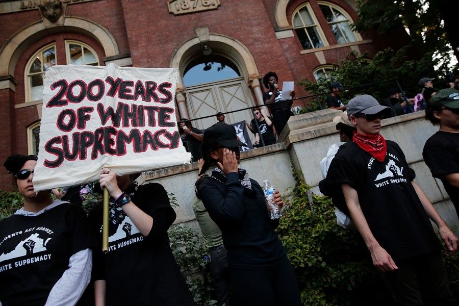 Protesters with the group Students Act Against White Supremacy speak on the campus of the University of Virginia during an event marking the one year anniversary of a deadly clash between white supremacists and counter protesters August 11, 2018 in Charlottesville, Virginia. (AFP)