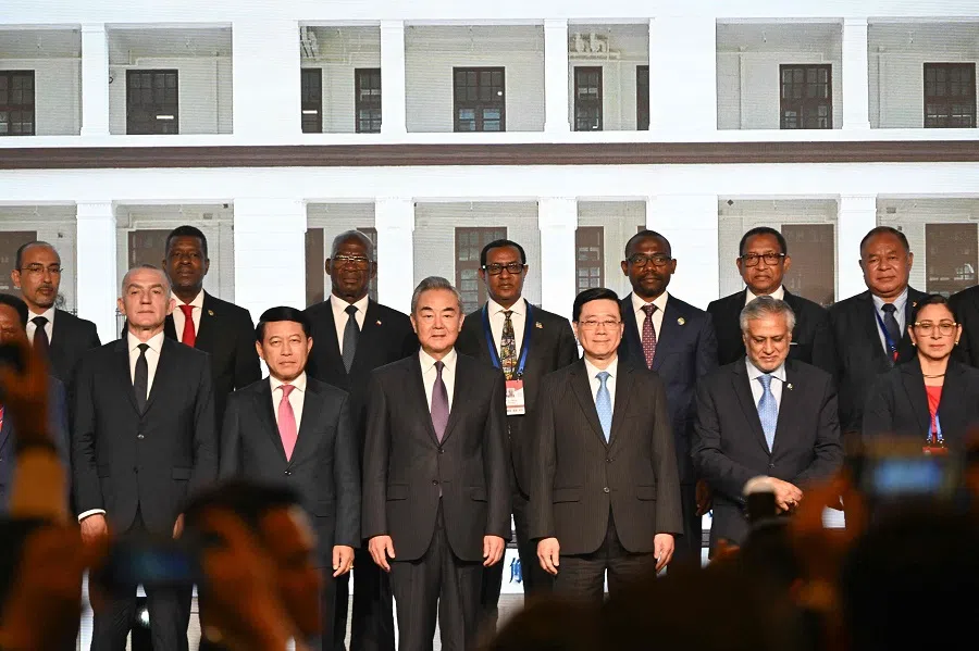 China’s Foreign Minister Wang Yi (front, third from left), Hong Kong Chief Executive John Lee (front, third from right), and nations’ representatives pose for a group photo after the signing ceremony of the Convention on the Establishment of the International Organization For Mediation at the Grand Hyatt hotel in Hong Kong on 30 May 2025.  (Peter Parks/AFP)