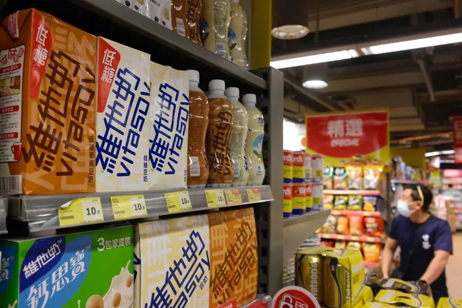 Soy milk drinks produced by local beverage brand Vitasoy (left) are displayed on a supermarket shelf in Hong Kong on 5 July 2021. (Anthony Wallace/AFP)