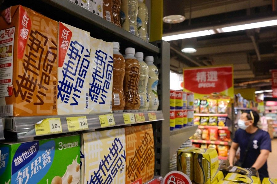 Soy milk drinks produced by local beverage brand Vitasoy (left) are displayed on a supermarket shelf in Hong Kong on 5 July 2021. (Anthony Wallace/AFP)