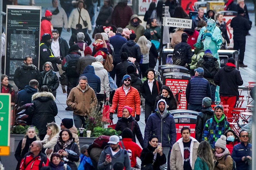 People walk on Times Square in Manhattan, in New York, US, 14 November 2022. (Eduardo Munoz/Reuters)