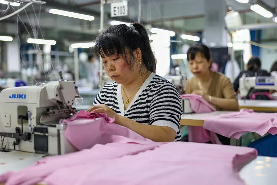 Employees sew clothes for export at a clothing factory in Tongren, in southwestern China’s Guizhou province, on 15 May 2025. (AFP)