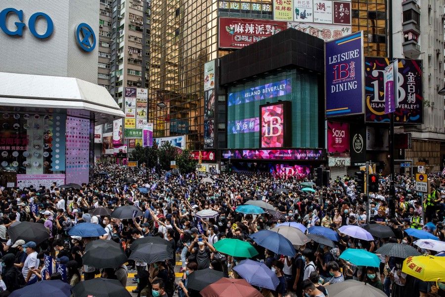 Pro-democracy protesters gather in Causeway Bay district of Hong Kong, 24 May 2020, ahead of planned protests against a proposal to enact new security legislation in Hong Kong. (Isaac Lawrence/AFP)