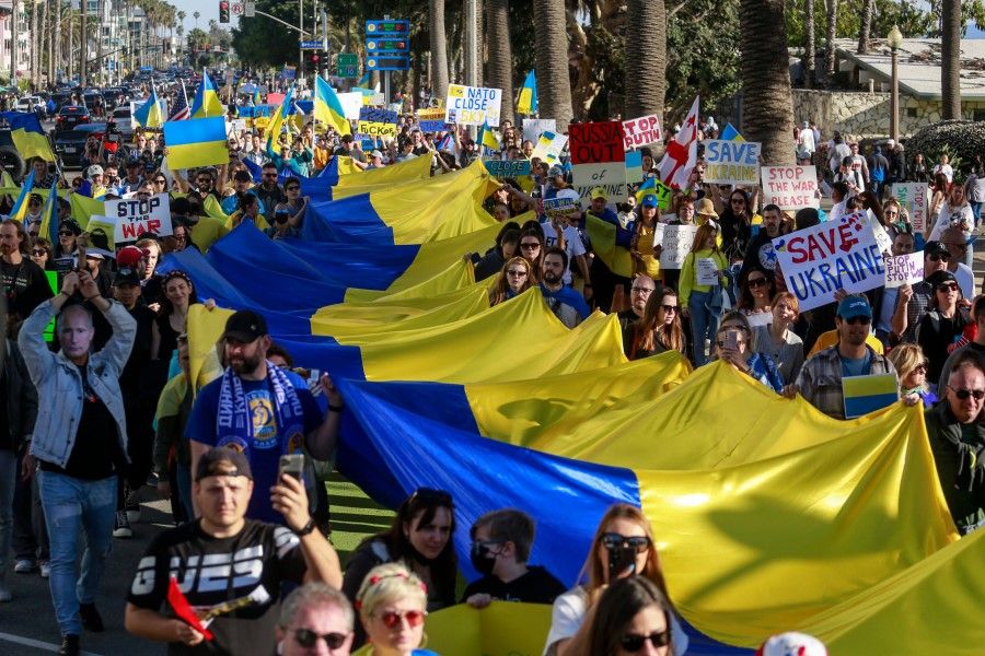 Demonstrators march during a rally in support of Ukraine, in Santa Monica, California, on 27 February 2022. (Ringo Chiu/AFP)