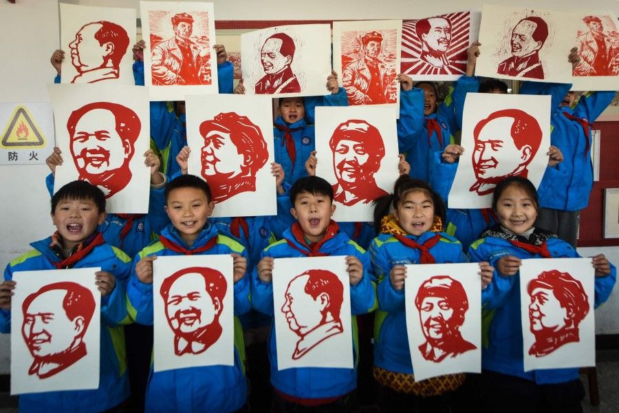 Students display their paper cutting portraits of the late former Chinese Communist Party leader Mao Zedong ahead of his 127th birthday which falls on 26 December, in Lianyungang in eastern China's Jiangsu province on 23 December 2020. (STR/AFP)