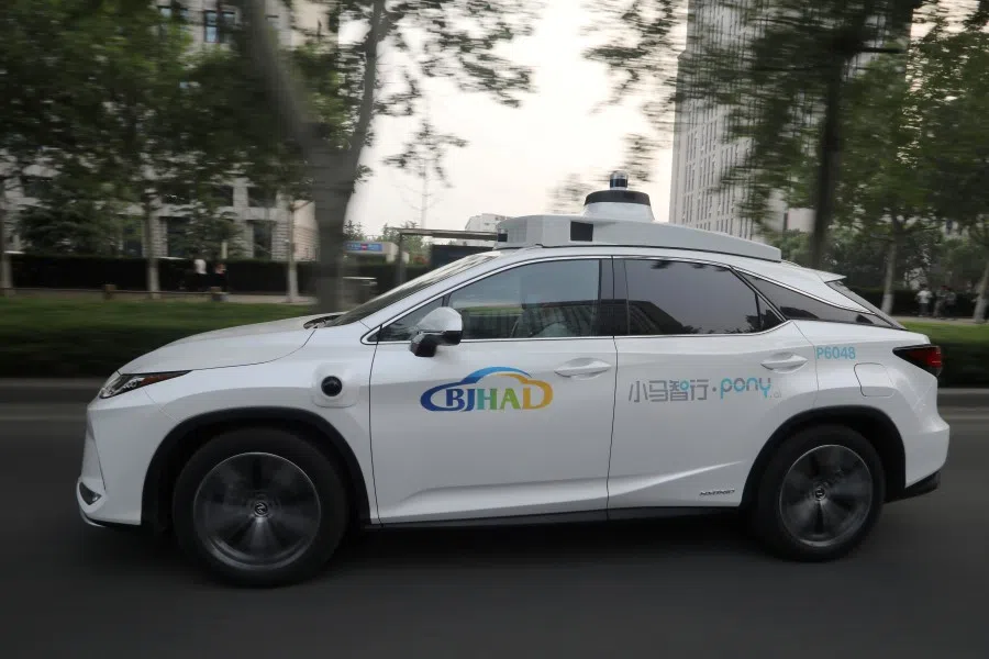A Lexus vehicle equipped with an autonomous driving system drives on a road during a test event, in Beijing, China, 13 May 2021. (Tingshu Wang/Reuters)