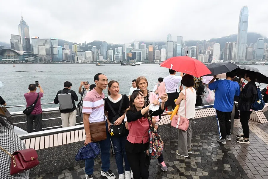 Tourists from mainland China visit the Tsim Sha Tsui waterfront in Hong Kong on 1 May 2024. (Peter Parks/AFP)