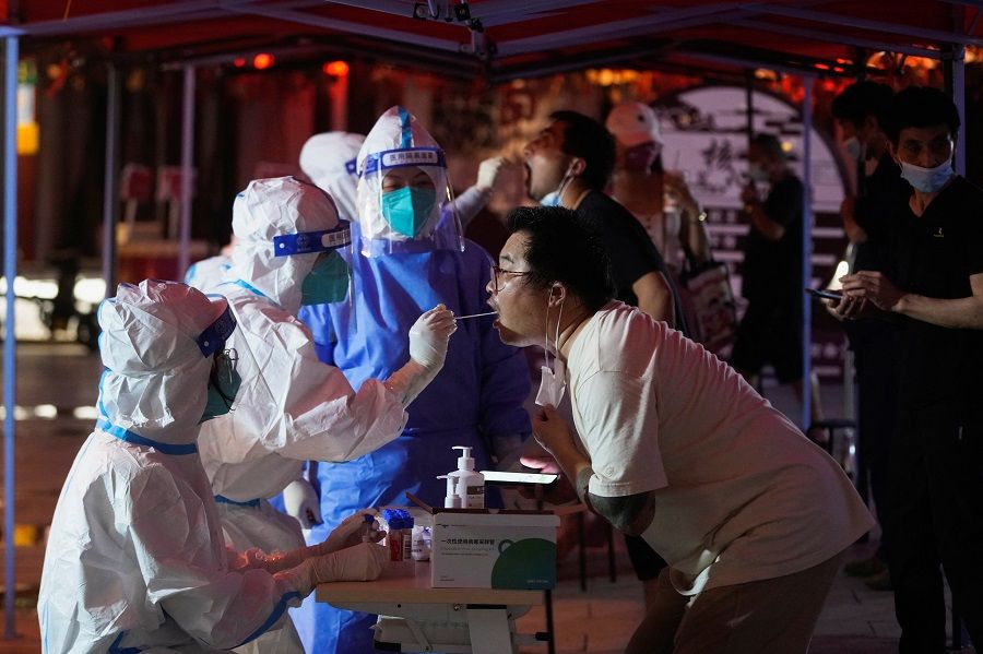 A man gets tested for Covid-19 at a nucleic acid testing site in Shanghai, China, 12 July 2022. (Aly Song/Reuters)