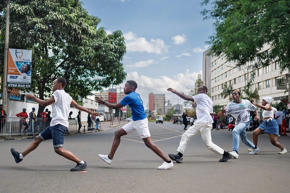 A group of youth perform a dance sequence at the intersection of Parliament road during a social media video shoot in Nairobi’s central business district on 17 November 2024. (Tony Karumba/AFP)