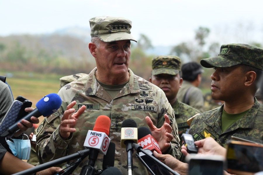 General Charles Flynn, commanding general of the United States Army Pacific (USARPAC) speaks to members of the media as he visited the troops during the live exercise as part of the US-Philippines joint military exercise "Balikatan" at Fort Magsaysay in Nueva Ecija province, north of Manila on 13 April 2023, while Philippine Army Comanding General Romeo Brawner (right) listens. (Ted Aljibe/AFP)