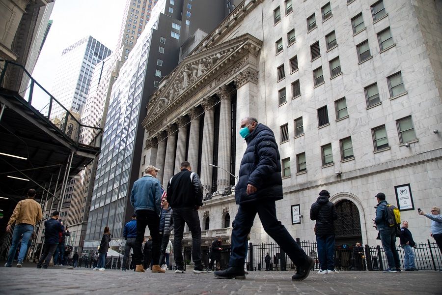 Pedestrians pass in front of the New York Stock Exchange (NYSE) in New York, US, on 15 March 2022. (Michael Nagle/Bloomberg)