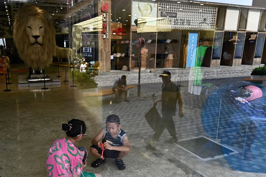 Children play in a store in a shopping mall in Beijing on 4 August 2024. (Pedro Pardo/AFP)