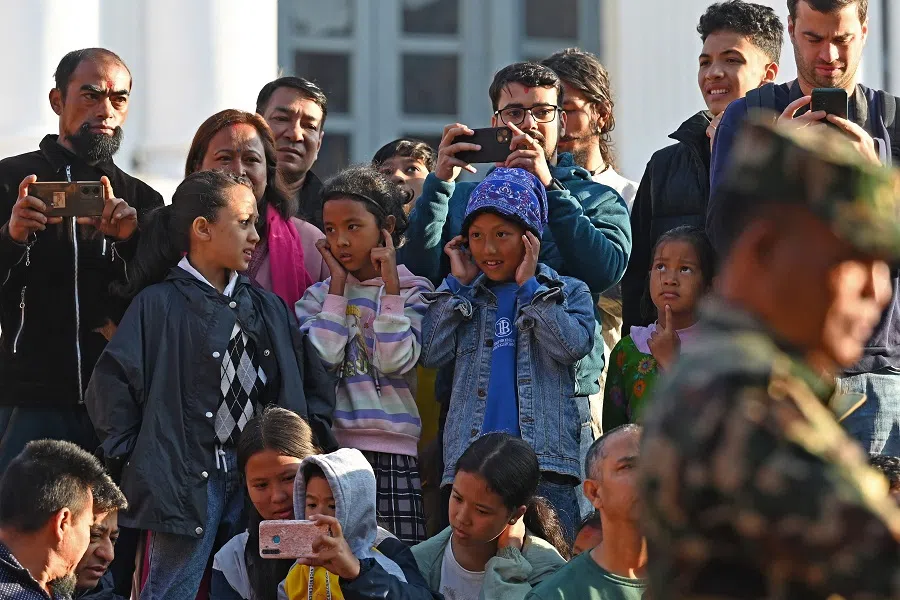 People watch as devotees prepare to sacrifice a goat during the celebrations on the ninth day of the Hindu Dashain Festival that marks the triumph of good over evil, in Kathmandu, Nepal, on 23 October 2023. (Prakash Mathema/AFP)