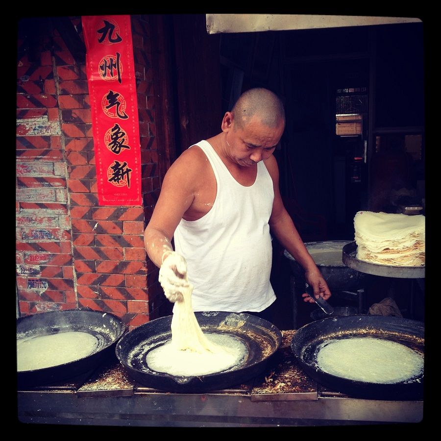 This street side pancake maker is busy at work preparing batches of the local variety consumed in Quanzhou, Fujian known as runbing (润饼).