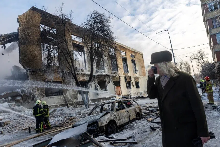 A man walks past a building that was hit by a Russian drone, amid Russia’s attack on Ukraine, in Kyiv, Ukraine, on 12 January 2026. (Thomas Peter/Reuters)