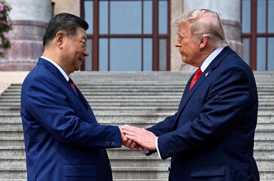 US President Donald Trump (right) greets Chinese President Xi Jinping at the Great Hall of the People on 14 May 2026, in Beijing, China. (Kenny Holston/Reuters)