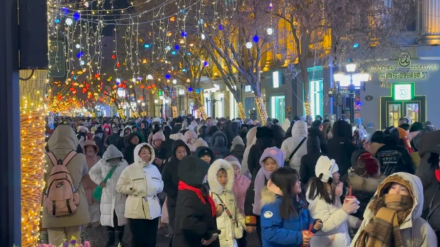 People walk along a street in Harbin. (Photo: Daryl Lim)