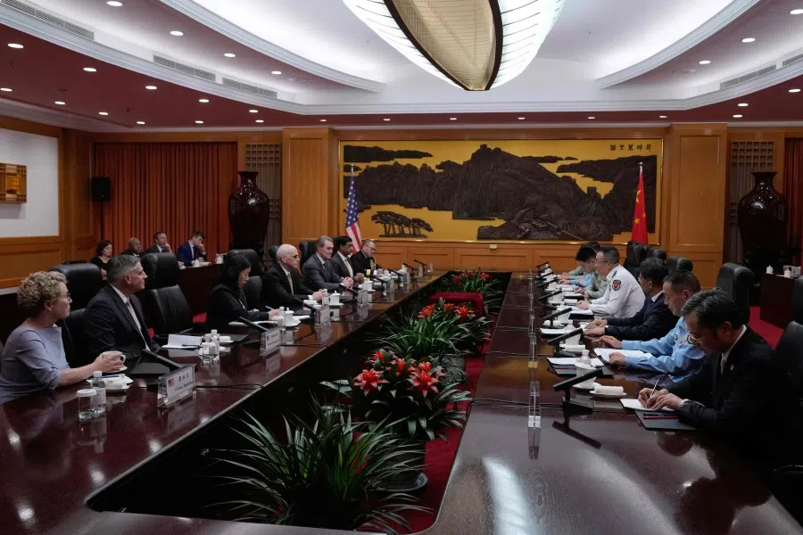 China’s Defence Minister Dong Jun (fourth from right, in white) speaks with US Representative Adam Smith (fourth from left), Democratic ranking member of the House Armed Services Committee, with a bipartisan group of US lawmakers at the Ministry of Defence in Beijing on 22 September 2025. (Mahesh Kumar A./AFP)