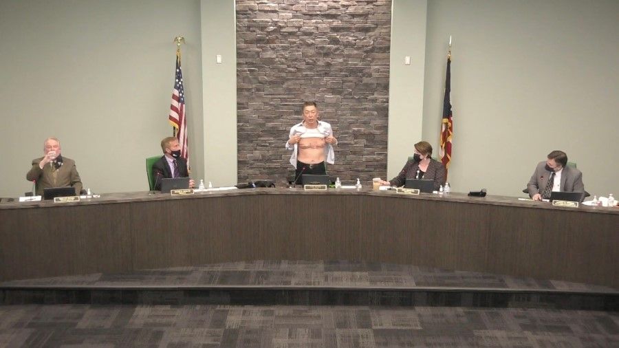 At a meeting of the board of trustees in West Chester Township, Ohio, on 23 March 2021, board chairman Lee Wong spoke out against the recent wave of anti-Asian attacks in the US, where he unbuttoned his shirt to show the scars across his chest from his military service, asking: "Now, is this patriot enough?" (West Chester Township, Ohio/Handout via Reuters)