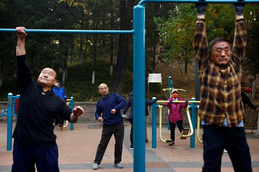 Elderly people exercise in the morning at a park in Beijing, China, 10 November 2022. (Tingshu Wang/Reuters)