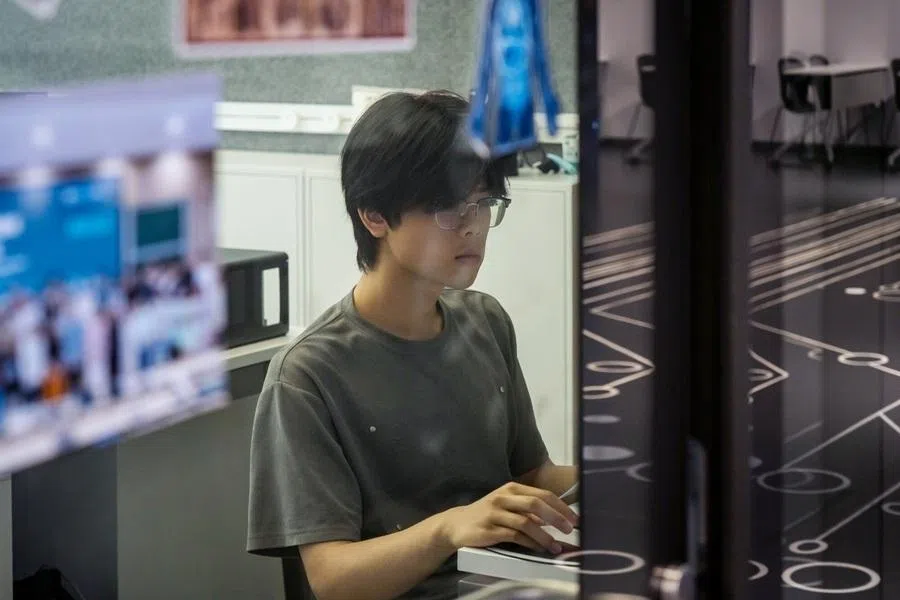A student at work in the Artificial Intelligence Learning Hall at Zhejiang University's Zijingang Campus in Hangzhou, China, on Tuesday, June 2, 2026. China is preparing to spend around 2 trillion yuan ($295 billion) over the next five years on building data centers across the country, fueling Beijing’s ambition to propel the domestic AI sector and surpass the US in a potentially game-changing technology. Photographer: Qilai Shen/Bloomberg