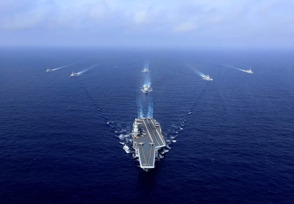 This file photo taken on 18 April 2018 shows China's aircraft carrier, the Liaoning (centre), sailing during a drill at sea. (STR/AFP)