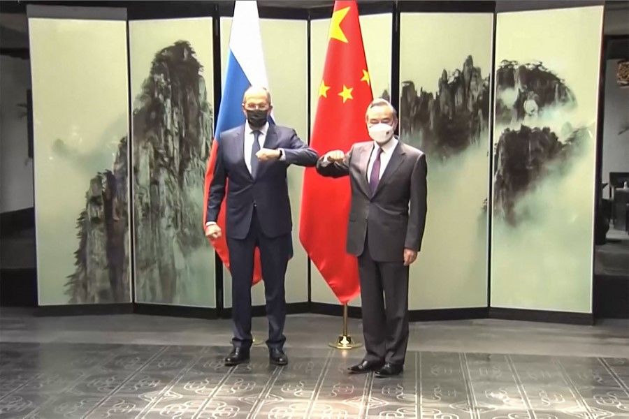 This screengrab taken on 30 March 2022 from video by state broadcaster China Central Television (CCTV) via AFPTV shows Russian Foreign Minister Sergei Lavrov (left) meeting his Chinese counterpart Wang Yi during his first visit to China since Moscow launched its invasion of Ukraine in February, at their meeting in Huangshan in China's Anhui province. (AFP)
