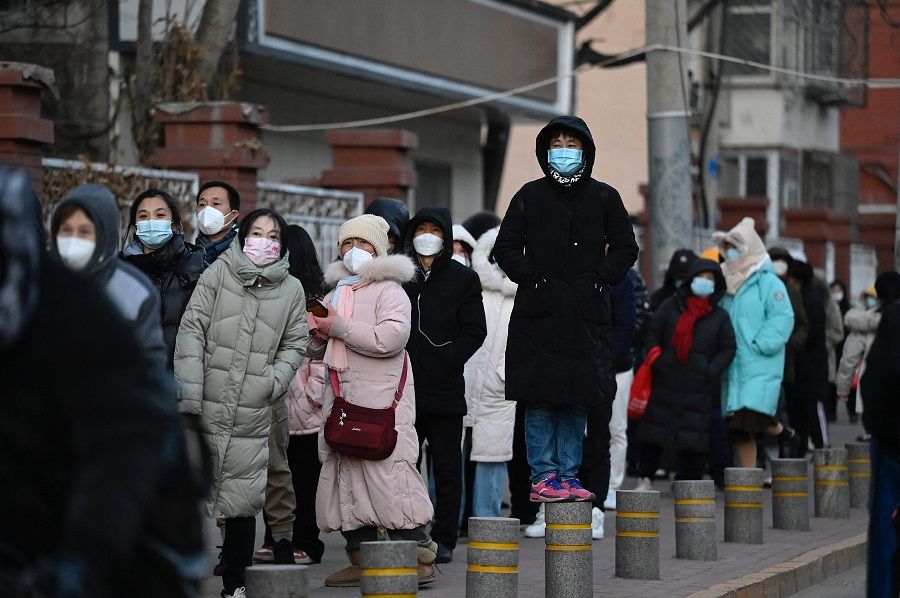 People wait in a long queue to be tested for Covid-19 at a nucleic acid testing site in Beijing, China, on 3 December 2022. (Jade Gao/AFP)