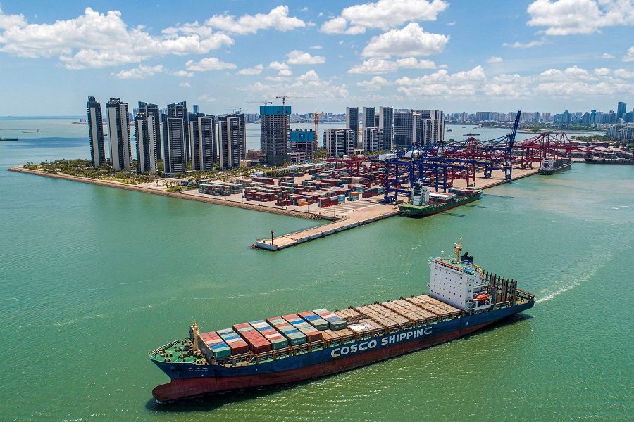 This aerial photo taken on 17 May 2021 shows a cargo ship loaded with containers leaving a port in Haikou, Hainan province, China. (STR/AFP)