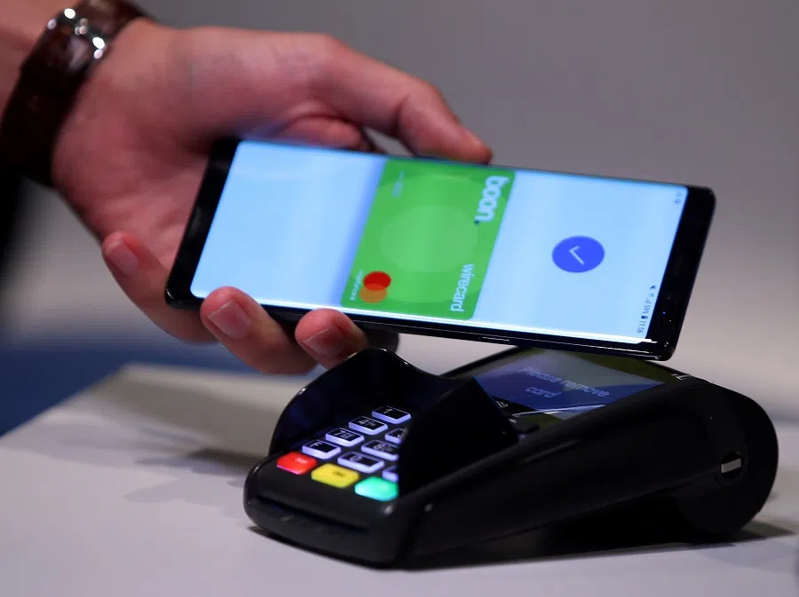 An employee of Wirecard AG, an independent provider of outsourcing and white label solutions for electronic payment transactions, presents the contactless payment system "boon" at the company's headquarters in Aschheim, Munich, Germany on 6 September 2018. (Michael Dalder/File Photo/Reuters)