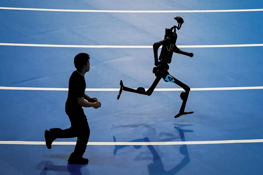 A Unitree Robotics humanoid robot takes part in a 400-metre race at the inaugural World Humanoid Robot Games, at the National Speed Skating Oval in Beijing, China, 15 August 2025. (Tingshu Wang/Reuters)