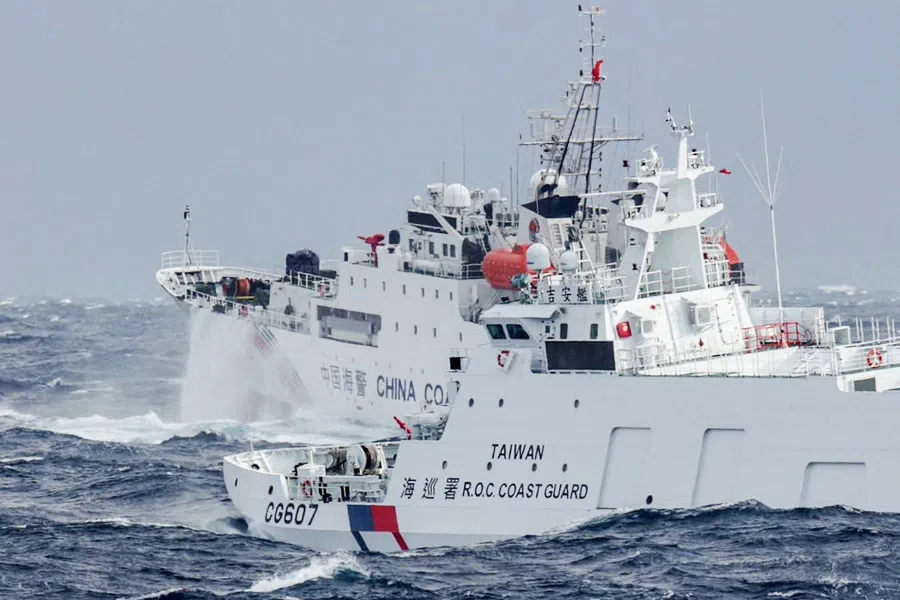 This handout photo taken and released by Taiwan’s Coast Guard on 12 December 2024 shows a Taiwanese coast guard ship (right) monitoring a Chinese coast guard ship, a few nautical miles from Taiwan’s northeastern coast. (Handout/Taiwan Coast Guard/AFP)