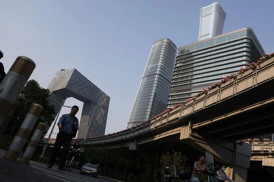 A man walks at the central business district in Beijing, China, on 12 May 2026.