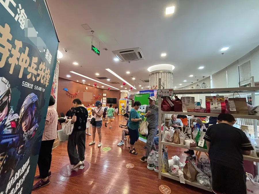 Parents waiting for children at a tuition centre in Xuhui district in Shanghai, with over 60 delivered lunches left at a rack.