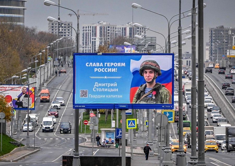 This file photo taken on 24 October 2022 shows a poster displaying a Russian soldier with a slogan reading "Glory to the Heroes of Russia" decorating a street in Moscow, Russia. (Yuri Kadobnov/AFP)