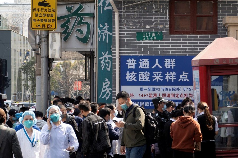 Residents line up outside a nucleic acid testing site of a hospital, following Covid-19 cases in Shanghai, China, 11 March 2022. (China Daily via Reuters/File Photo)