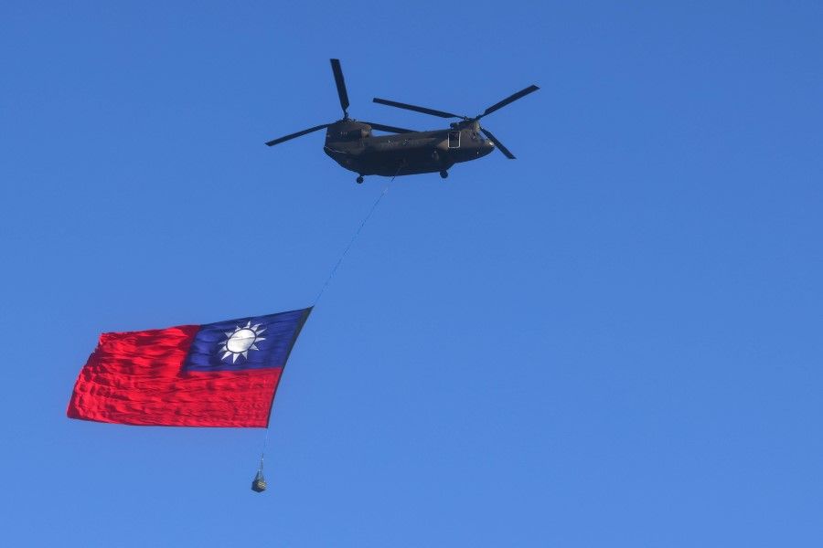 A Taiwan flag is carried across the sky during a national day rehearsal in Taipei, Taiwan, 5 October 2021. (Ann Wang/Reuters)