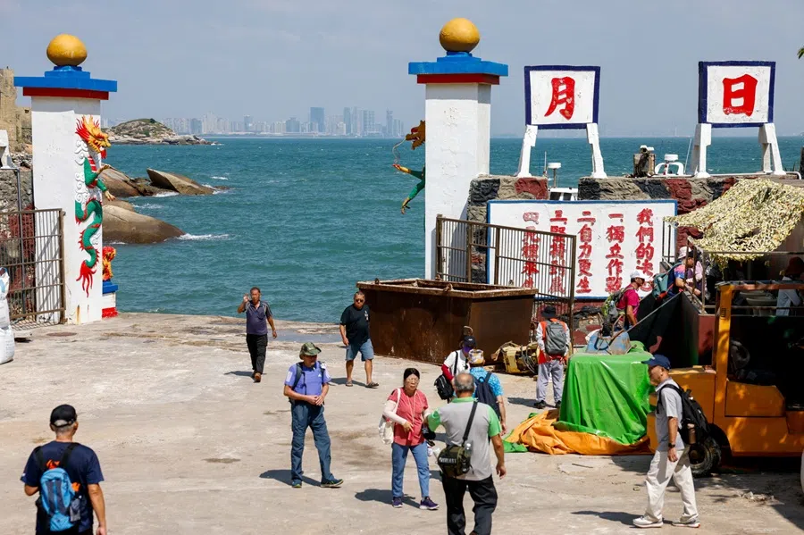 Tourists gather at the port and entrance of Dadan, with China's Xiamen visible in the background, on Dadan Island, in Kinmen, Taiwan, 18 October 2025. (Ann Wang/Reuters)
