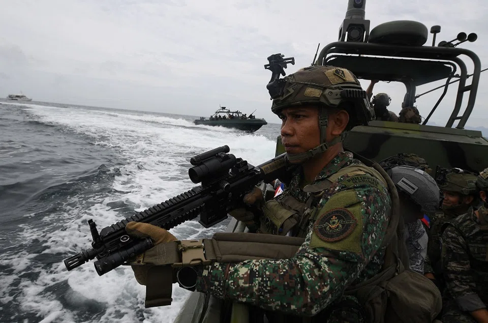 A Philippine marine aboard their patrol boat stands guard during a joint visit, board and seizure (VBS) exercise with their US and South Korean counterparts with members of Japan’s self-defence forces as observers, at the marines training base in Ternate town, Cavite province, west of Manila on 22 October 2024, as part of the annual Philippines-US joint marines exercise dubbed Kamandag (Venom). (Ted Aljibe/AFP)