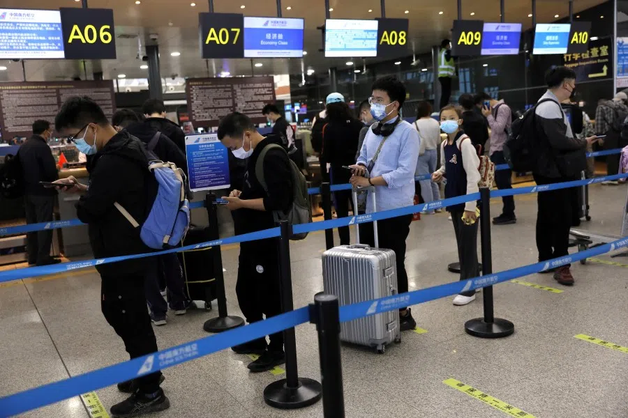 Travellers line up at a ticket counter, ahead of China's National Day and Golden Week holiday, at Taoxian International Airport in Shenyang, Liaoning province, China, 30 September 2021. (Tingshu Wang/Reuters)