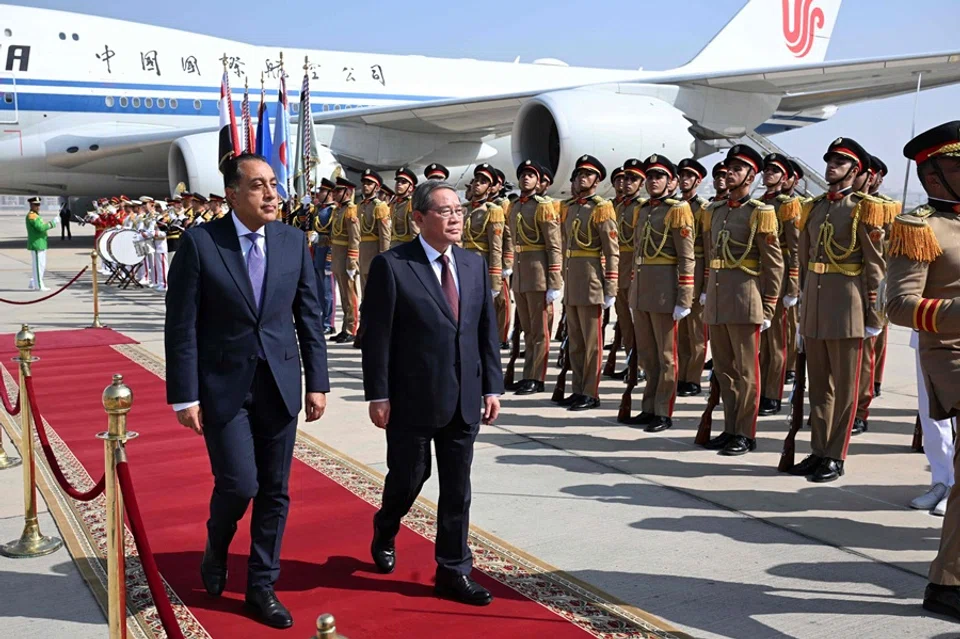 Egypt’s Prime Minister Mostafa Madbouly welcomes China’s Premier Li Qiang upon his arrival at the Cairo International Airport in Egypt’s capital on  9 July 2025. (AFP)