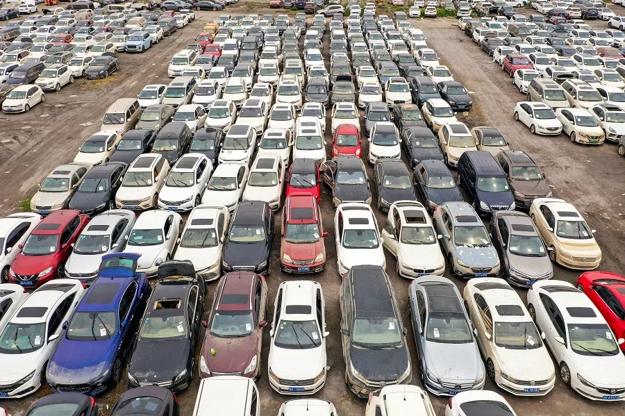 This aerial photo taken on 10 August 2021 shows vehicles damaged by floods in July at a parking lot, some of which will be discarded, in Zhengzhou, Henan province, China. (STR/AFP)