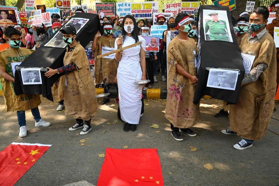 Protesters hold coffins displaying a picture of Chinese President Xi Jinping (left) and Myanmar military chief Senior General Min Aung Hlaing (right) during a demonstration in New Delhi on 3 March 2021, to protest against the military coup in Myanmar. (Prakash Singh/AFP)