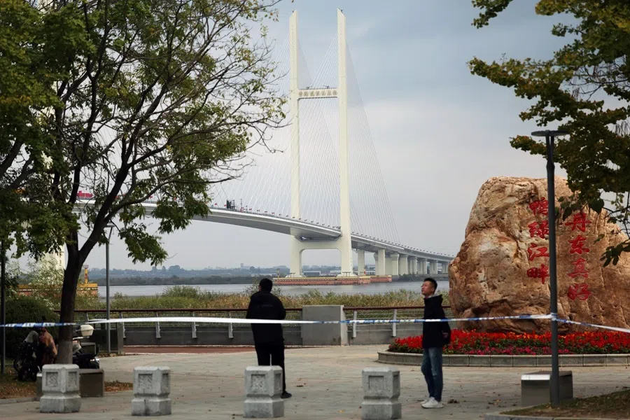 Security personnel keep watch at a cordoned-off waterfront before the opening ceremony for the New Yalu River Bridge in Dandong, Liaoning, China, which links to North Korea’s Sinuiju city, on 15 October 2026.