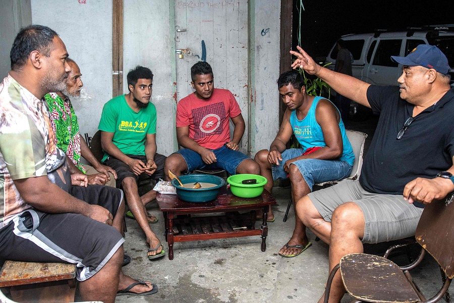 This photo taken on 5 August 2020 shows local residents drinking kava at Mauri Kava Bar in Suva, Fiji. (Leon Lord/AFP)