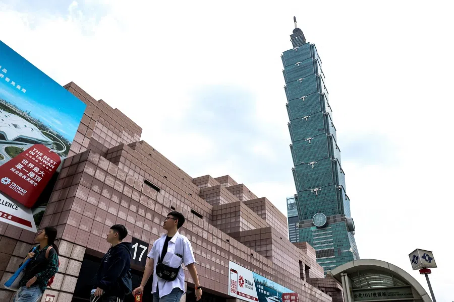 People walk in front of Taiwan’s landmark Taipei 101 building in Taipei on 7 April 2025. (I-Hwa Cheng/AFP)
