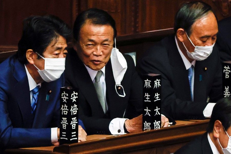 Japan's former prime ministers Shinzo Abe, Taro Aso, and Yoshihide Suga attend a parliamentary session at the lower house of Parliament in Tokyo, Japan, 10 November 2021. (Issei Kato/Reuters)